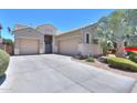 Single-Gathering home with well-maintained landscaping, dual-car garage, and concrete driveway at 19969 N Santa Cruz Dr, Maricopa, AZ 85138
