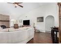 Bright living room with a brick fireplace, plush sofa, and archway entrance at 2312 W Temple St, Chandler, AZ 85224