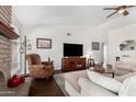 Inviting living room showcasing a brick fireplace, neutral sofa, and a ceiling fan at 2312 W Temple St, Chandler, AZ 85224