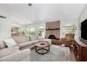 Spacious living room featuring a brick fireplace, plush sofa, and wood-look flooring at 2312 W Temple St, Chandler, AZ 85224