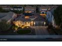 This aerial view highlights a lovely desert home with solar panels, nice landscaping, and a paved driveway at 3049 E Longhorn Dr, Gilbert, AZ 85297