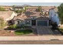 Charming home featuring stone veneer, a well-manicured front yard, and solar panels, perfect for energy-efficient living at 3049 E Longhorn Dr, Gilbert, AZ 85297