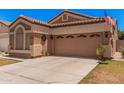 Attractive single-story house featuring an attached two-car garage, a well-maintained lawn and a neutral color scheme at 3440 E Southern Ave # 1088, Mesa, AZ 85204