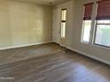 Spacious living room with new laminate wood flooring and ample natural light from the large windows at 4523 E Gleneagle Dr, Chandler, AZ 85249