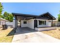 Charming single story home with covered parking, white exterior and low brick wall surrounding the property at 527 N Pasadena --, Mesa, AZ 85201