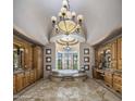 Luxurious bathroom featuring a jacuzzi tub with decorative tile work, chandelier and dual vanities at 6305 E Arabian Way, Paradise Valley, AZ 85253
