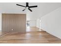Open-concept living room boasts hardwood floors, an accent wall, and a modern ceiling fan for added comfort at 6420 S Wilson St, Tempe, AZ 85283