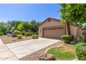 Exterior of single story home, showing two car garage and desert landscaping at 6758 W Quail Ave, Glendale, AZ 85308
