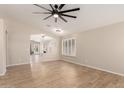 Spacious living room features neutral paint, wood floors, and ample natural light at 723 N Joshua Tree Ln, Gilbert, AZ 85234
