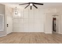 Bright, open living room with neutral paint, wood floors, and a large ceiling fan at 723 N Joshua Tree Ln, Gilbert, AZ 85234