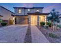 Well-maintained two-story home boasts a welcoming facade with stone accents and a neatly landscaped front yard at 12122 W Levi Dr, Avondale, AZ 85323