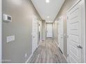 Bright hallway showcasing modern flooring and neutral walls, connecting various rooms within the home seamlessly at 12122 W Levi Dr, Avondale, AZ 85323