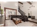 Open-concept living room with wood beams, high ceilings, fireplace and a cozy seating arrangement at 1353 W Kiowa Ave, Mesa, AZ 85202