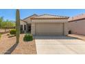 A single-story home featuring a desert landscape, tile roof, and a two-car garage in a sunny location at 17108 N Estrella Vista Dr, Surprise, AZ 85374