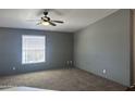 Spacious living room featuring neutral walls, carpet, and a ceiling fan at 18026 N Cave Creek Rd # 140, Phoenix, AZ 85032