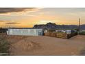 Exterior view of home with desert landscaping and scenic mountain backdrop at sunset at 2242 E 12Th Ave, Apache Junction, AZ 85119
