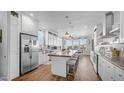 A stunning kitchen featuring white cabinets, stainless steel appliances, and a large center island with seating at 2242 E 12Th Ave, Apache Junction, AZ 85119