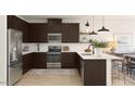 Modern kitchen features stainless steel appliances, dark wood cabinetry, a tiled backsplash, and a bright island at 23433 W Burton Ave, Buckeye, AZ 85326