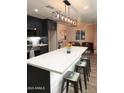 Bright kitchen features a large quartz island with seating, stainless appliances, and overlooks the living room at 236 E Minton Dr, Tempe, AZ 85282