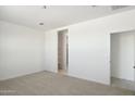 Neutral bedroom with carpet, ample closet space, and an attached bathroom at 25464 W Fraktur Rd, Buckeye, AZ 85326