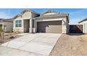 Attractive single-story home featuring a two-car garage and low-maintenance desert landscaping at 25477 W Fraktur Rd, Buckeye, AZ 85326