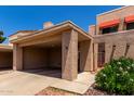 Inviting home with desert landscaping, a covered carport, and shade coverings on the windows at 26 E Coral Gables Dr, Phoenix, AZ 85022