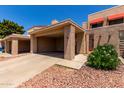 Charming home with a covered carport, desert landscaping, and direct access to the home at 26 E Coral Gables Dr, Phoenix, AZ 85022