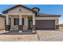 Charming home with a well-manicured front yard, covered porch, and a convenient two-car garage at 3629 E Rochelle Cir, Mesa, AZ 85213
