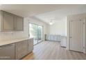 Open kitchen and eating area offers gray cabinets, counter space and sliding door access to the outside at 3811 S Mill Ave, Tempe, AZ 85282