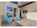 Charming front porch with cozy blue chairs, colorful potted plants, and stylish decor, creating a welcoming entrance at 4182 W Park Ave, Chandler, AZ 85226
