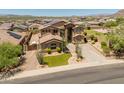 A beautiful home with solar panels, a lush front lawn, and desert landscaping at 4418 W Yoosooni Dr, New River, AZ 85087