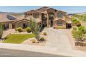 A well-maintained two-story home with desert landscaping and an American flag at 4418 W Yoosooni Dr, New River, AZ 85087