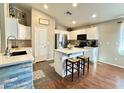 Modern kitchen featuring white cabinets, stainless steel appliances, and island with seating at 45499 W Sky Ln, Maricopa, AZ 85139