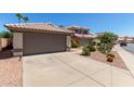 Lovely home with a well-kept front yard and a convenient two-car garage, complemented by desert landscaping at 5018 W Wikieup Ln, Glendale, AZ 85308