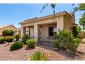 Inviting front porch with lush landscaping adds charm to this lovely home at 5102 S Peachwood Dr, Gilbert, AZ 85298