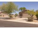 Charming single-story home with well-maintained landscaping and a spacious driveway at 718 E Devon Dr, Gilbert, AZ 85296