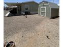Spacious backyard area with gravel and storage shed with room to add your own personal touches at 7807 E Main St # Cc-98, Mesa, AZ 85207