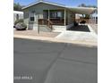 Charming home with covered front porch and carport area and low maintenance landscaping at 7807 E Main St # Cc-98, Mesa, AZ 85207