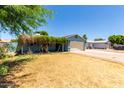 Charming single-story home with a well-maintained lawn and a cozy, covered porch entrance at 8042 W Mariposa Dr, Phoenix, AZ 85033