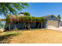 Charming single-story home with a well-maintained lawn and a cozy, covered porch entrance at 8042 W Mariposa Dr, Phoenix, AZ 85033