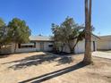 Ranch style home featuring mature trees and desert landscaping in the front yard at 8114 E Jackrabbit Rd, Scottsdale, AZ 85250