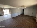 View of a spacious living room with connecting room featuring sliding glass doors to the backyard at 8114 E Jackrabbit Rd, Scottsdale, AZ 85250