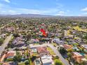 An aerial view of a neighborhood with a red arrow indicating a specific property, showcasing its location and surroundings at 8604 S Oak St, Tempe, AZ 85284