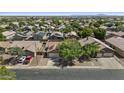 An aerial view of a neighborhood showing many homes with tile roofs and mature landscaping at 10727 E El Moro Ave, Mesa, AZ 85208