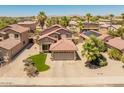 Aerial view of a well-maintained home with desert landscaping, red tile roof, and solar panels at 1374 E 10Th Pl, Casa Grande, AZ 85122