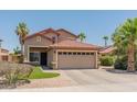 Inviting two-story home boasts a manicured front yard, mature palm trees, and a spacious two-car garage at 1374 E 10Th Pl, Casa Grande, AZ 85122