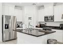 A well-equipped kitchen features granite countertops, stainless steel appliances, and white cabinets at 14360 W Pershing St, Surprise, AZ 85379