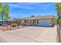 Single Gathering home with well-maintained driveway and desert landscaping, complemented by a convenient one-car garage at 14808 N 37Th Way, Phoenix, AZ 85032
