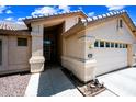 Close-up of the home's entrance, highlighting its well-maintained stucco and attached two-car garage at 15194 W Vale Dr, Goodyear, AZ 85395
