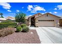 Inviting single-level home with a well-manicured yard, desert landscaping, and a two-car garage at 15194 W Vale Dr, Goodyear, AZ 85395
